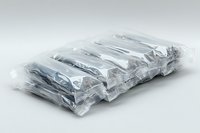 Stack of folded white t-shirts wrapped in transparent plastic packaging on light background, ready for retail or wholesale distribution and storage.