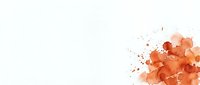 Abstract orange watercolor splash with paint splatters on white background for creative design projects and artistic compositions.
