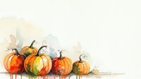 Watercolor pumpkins in autumn colors with paint splatters on white background for seasonal designs and fall decorations.
