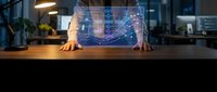 Young male professional displaying holographic data visualization interface at wooden desk in modern office environment for technology and business concepts.