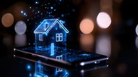 Glowing blue hologram house floating above smartphone screen with bokeh lights background, representing smart home technology and digital real estate concept.