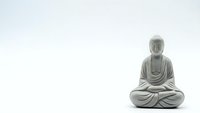 Stone Buddha statue in meditation pose on white background for zen mindfulness and spiritual design projects.