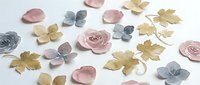 Dried flowers and leaves in pink, gold, and gray tones scattered on white background, suitable for craft projects, wedding designs, and decorative compositions.