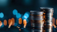 Stacked silver coins on dark background with blurred bokeh lights, representing wealth, savings and financial growth. Banking concept with metallic currency.