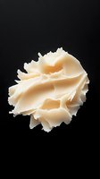 Creamy whipped butter or dairy product isolated on black background, suitable for food packaging, culinary design, and advertising applications.