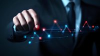 Businessman pointing at glowing financial chart with red and blue dots connected by lines showing market trends and analytics on dark background.