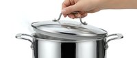 Caucasian hand lifting glass lid off stainless steel cooking pot with handles, isolated on white background for kitchenware and culinary content.