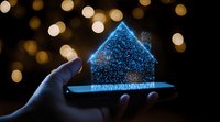Glowing blue hologram house floating above smartphone in dark room with bokeh lights background creates magical atmosphere of future technology.