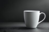White ceramic coffee mug on dark background with dramatic lighting and shadow effect, minimalist composition for cafe menu, restaurant promotion or beverage advertising.
