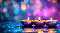 Lit oil lamps with glowing flames arranged in a row on a sparkling surface, surrounded by soft bokeh lights in purple, blue, and pink tones, suitable for festive celebrations and spiritual occasions.