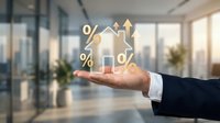 Businessman hand holding floating house icons with percentage and arrow symbols representing real estate investment growth and mortgage rates in modern office.