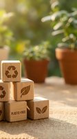 Wooden blocks with eco symbols stacked on natural jute fabric with blurred potted plants background representing sustainable living and environmental awareness.
