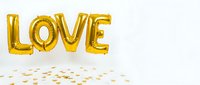 Gold foil balloons spelling LOVE floating above scattered heart confetti on white background, perfect for Valentine's Day and celebration decor.