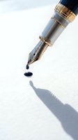 Luxury fountain pen with gold details dropping blue ink on white paper creating shadow for writing and calligraphy concepts.