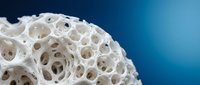 White porous organic structure with intricate holes and cavities against blue gradient background for scientific research and educational materials.