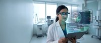 Young Asian female doctor in white coat uses augmented reality holographic display with brain scan in modern medical laboratory.