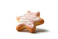 Star-shaped sugar cookie with pink and white frosting drizzle on isolated white background, soft shadows add depth to baked treat.