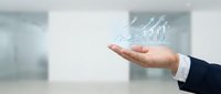 Businessman hand presenting holographic growth chart with upward trending arrows in modern office environment for financial success presentations.