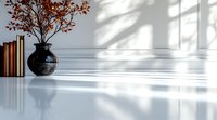 Minimalist interior with black ceramic vase holding red autumn branches on glossy white surface, casting dramatic shadows from window light. Natural sunlight creates geometric patterns.