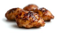 Grilled chicken thighs with crispy golden skin and caramelized surface isolated on white background for culinary and food design projects.