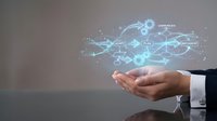 Business professional holding glowing digital network with connected icons representing modern technology communication and data flow concepts.