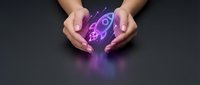 Female hands cupping a glowing neon rocket hologram on dark background, symbolizing startup launch, innovation, and business growth.