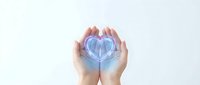 Hands gently holding glowing blue heart symbol representing healthcare, medical protection, love and wellness concepts for charity campaigns.
