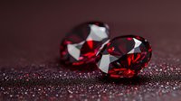 Sparkling red gemstones on dark background with glitter. Luxurious oval cut rubies or garnets showcase brilliant facets and deep crimson color in dramatic lighting.