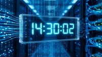 Futuristic digital clock display showing time in glowing blue holographic interface with circuit board patterns and data streams for technology concepts.