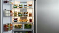 Open refrigerator filled with organized glass containers of fresh vegetables, fruits, salads, beverages and prepared meals for meal planning and healthy eating.