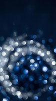 Abstract blue bokeh lights background with soft glowing circles and defocused illumination for festive celebrations and elegant design projects.