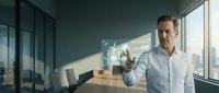 Professional businessman interacting with holographic interface technology in modern office boardroom with city skyline view for corporate presentations.