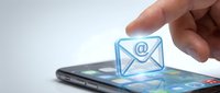 Close-up of hand holding glowing email icon above smartphone screen, representing digital communication, online messaging, and mobile contact technology for business and personal correspondence.