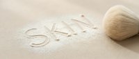Sale written in sand with seashell on beach, suitable for travel, vacation, and coastal marketing materials.
