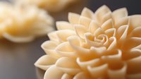 Delicate cream-colored dahlia flower petals in macro photography showing intricate spiral pattern and soft natural lighting for wedding and romantic designs.