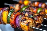 Grilled chicken kebabs with colorful bell peppers, zucchini, and red onions on metal skewers, showing charred edges and marinade glaze in macro view.