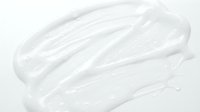 White cosmetic cream or lotion texture swatch isolated on white background, ready for skincare product packaging, beauty design, and cosmetics marketing materials.