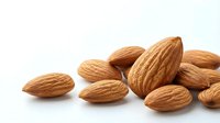 Scattered almonds on white background, isolated nuts ready for food packaging, culinary design, and healthy snack marketing materials.