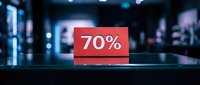 Red discount tag showing 70% off on a glossy counter in a blurred retail store, perfect for sale promotions and shopping campaigns.