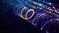 Glowing neon spiral light trails with particles creating dynamic energy waves on dark background for digital art and futuristic design projects.
