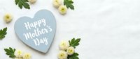 Happy Mother's Day heart-shaped card with yellow chrysanthemums and green leaves on white background for greeting cards and holiday celebrations.