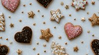 Festive holiday cookies with heart and star shapes decorated with colorful sprinkles and sugar on white background. Perfect for seasonal celebrations.
