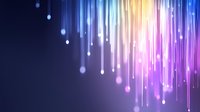 Glowing colorful light streaks falling from above against dark blue background, creating magical atmosphere for festive designs and digital backgrounds.