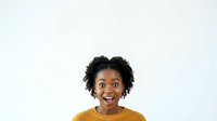 Young woman with dark curly hair and medium skin tone wearing mustard yellow shirt, smiling broadly at camera against white background for portrait and commercial use.