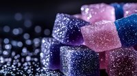 Colorful glittering cubes with sparkling particles on dark background, suitable for luxury branding, festive designs, and abstract digital art projects.