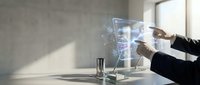 Businesswoman in formal black attire interacting with holographic digital interface displaying data visualization on modern office desk with minimalist workspace.