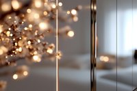Soft glowing bokeh lights create dreamy atmosphere with reflective surfaces and blurred golden sparkles, adding warmth and luxury to festive background.