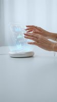 Female hands interacting with futuristic holographic display showing data charts and graphs on white device for business analytics and digital innovation.