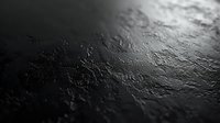 Dark textured surface with water droplets creating dramatic shadows and highlights in monochrome. Abstract wet background with condensation and moisture patterns.