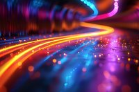 Vibrant light trails create dynamic motion effect with glowing orange, blue and purple streaks against dark background, perfect for technology and innovation themes.